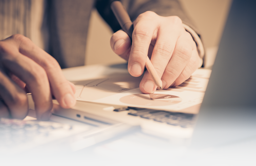 A man takes notes on a chart sheet