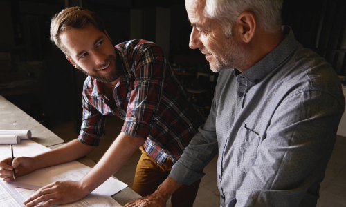 A father and his son work together in a workshop
