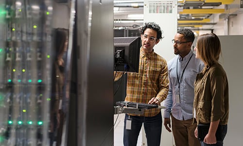 engineers using a computer in the server room